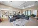 Bright living room featuring a large sectional sofa, patterned rug, and an open layout connecting to the kitchen at 1606 Navigator Rd, Punta Gorda, FL 33983