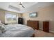 Relaxing bedroom featuring large window, stylish dresser, and a flat screen TV for casual viewing at 1606 Navigator Rd, Punta Gorda, FL 33983