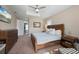 Spacious bedroom featuring a ceiling fan, dresser, and an en-suite bathroom with dual vanity at 1606 Navigator Rd, Punta Gorda, FL 33983