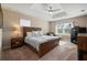 Spacious main bedroom with a tray ceiling, carpeted floor, and an abundance of natural light at 1606 Navigator Rd, Punta Gorda, FL 33983