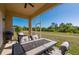 Screened-in patio features an outdoor dining set and peaceful backyard views at 1606 Navigator Rd, Punta Gorda, FL 33983