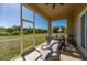 Relaxing screened-in patio for outdoor enjoyment with comfortable seating, and ceiling fan at 1606 Navigator Rd, Punta Gorda, FL 33983