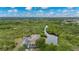 Aerial view of the building surrounded by lush greenery and waterways on a sunny day, offering a serene setting at 175 Kings Hwy # B2 1522, Punta Gorda, FL 33983