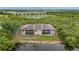 Aerial view of the building nestled between a pond and lush greenery, offering a tranquil and picturesque setting at 175 Kings Hwy # B2 1522, Punta Gorda, FL 33983