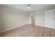 Well-lit bedroom has a ceiling fan, sleek floors, and convenient access to an ensuite bathroom at 175 Kings Hwy # B2 1522, Punta Gorda, FL 33983