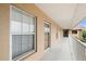 Hallway with neutral paint, exterior windows, access to stairwell, and multiple unit entry doors at 175 Kings Hwy # B2 1522, Punta Gorda, FL 33983