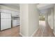 Hallway view of the white kitchen appliances and cabinetry with a view to the living area at 175 Kings Hwy # B2 1522, Punta Gorda, FL 33983