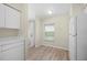 Bright kitchen nook with natural light, wood-look flooring, and white appliances for a modern aesthetic at 175 Kings Hwy # B2 1522, Punta Gorda, FL 33983