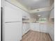 View of the bright kitchen, modern cabinets, and stainless steel appliances, and vinyl flooring at 175 Kings Hwy # B2 1522, Punta Gorda, FL 33983