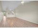 Bright living room with vaulted ceilings, a ceiling fan, wood-look flooring, and an open layout at 175 Kings Hwy # B2 1522, Punta Gorda, FL 33983
