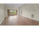 Bright living room with a ceiling fan, wood-look flooring, and access to a covered outdoor balcony at 175 Kings Hwy # B2 1522, Punta Gorda, FL 33983