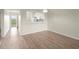 Inviting living room featuring wood-look floors and convenient access to the bright and modern kitchen at 175 Kings Hwy # B2 1522, Punta Gorda, FL 33983