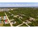 Wide aerial view of the community showing the home with a red pin, surrounded by greenery at 2229 Wakefield St, Port Charlotte, FL 33948