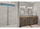 Modern bathroom featuring a tiled shower and a dual sink vanity with granite countertop at 2229 Wakefield St, Port Charlotte, FL 33948