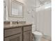 Bright bathroom features granite countertop on vanity, decorative wall flowers and a walk-in shower at 2229 Wakefield St, Port Charlotte, FL 33948