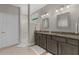 Ensuite bathroom featuring a double vanity, granite counters, and walk-in shower at 2229 Wakefield St, Port Charlotte, FL 33948