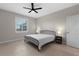 This bedroom features neutral walls, tile floors, a ceiling fan, a window and a closet door at 2229 Wakefield St, Port Charlotte, FL 33948