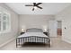 Bedroom with a ceiling fan, neutral paint, tile floor and two side tables with lamps at 2229 Wakefield St, Port Charlotte, FL 33948