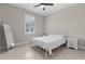 Well-lit bedroom with tile floors, a ceiling fan, and a window with view at 2229 Wakefield St, Port Charlotte, FL 33948