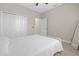 Neutral-toned bedroom with tile flooring, ceiling fan, closet doors, and a mirror at 2229 Wakefield St, Port Charlotte, FL 33948