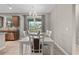 Bright dining room features a stylish light fixture and sliding glass doors to the outdoor pool area at 2229 Wakefield St, Port Charlotte, FL 33948