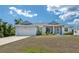 Charming single-story home featuring a two-car garage, covered porch, and well-maintained lawn at 2229 Wakefield St, Port Charlotte, FL 33948