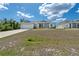Charming single-story home with a well-manicured lawn, attached garage, and inviting screened-in porch at 2229 Wakefield St, Port Charlotte, FL 33948