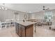 Spacious kitchen featuring an island with seating, adjacent to the dining and living areas at 2229 Wakefield St, Port Charlotte, FL 33948