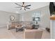 Bright living room features a comfortable sectional sofa, modern ceiling fan, and fireplace at 2229 Wakefield St, Port Charlotte, FL 33948