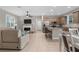 Open-concept living space with kitchen island, fireplace, and neutral decor at 2229 Wakefield St, Port Charlotte, FL 33948