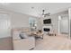 The cozy living room features neutral tones, a ceiling fan, and a modern electric fireplace at 2229 Wakefield St, Port Charlotte, FL 33948