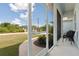 View from screened porch showing a seating area and neighborhood views at 2229 Wakefield St, Port Charlotte, FL 33948