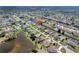 This aerial shows a home in a waterfront community with access to canals and a nearby lake at 229 Sportsman Rd, Rotonda West, FL 33947
