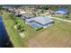 Aerial view of a backyard and a pool with a screened-in lanai, and a waterfront view at 229 Sportsman Rd, Rotonda West, FL 33947