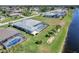 Aerial view of home's pool, screened lanai, manicured backyard, and waterfront views at 229 Sportsman Rd, Rotonda West, FL 33947