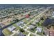 This aerial view highlights a waterfront neighborhood with canal access and lush green spaces near a lake at 229 Sportsman Rd, Rotonda West, FL 33947