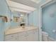 Well-lit bathroom featuring a large mirror and ample storage in white cabinets at 229 Sportsman Rd, Rotonda West, FL 33947