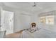 Bedroom featuring a double closet, a white ceiling fan, access to the hallway and neutral decor at 229 Sportsman Rd, Rotonda West, FL 33947
