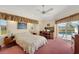 Comfortable bedroom with a work area and sliding glass doors to the pool at 229 Sportsman Rd, Rotonda West, FL 33947
