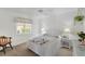 Well-lit bedroom featuring neutral carpet, a white ceiling fan and a large window bringing in natural light at 229 Sportsman Rd, Rotonda West, FL 33947