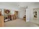 Spacious bedroom with bookshelves, a desk, and access to the hallway at 229 Sportsman Rd, Rotonda West, FL 33947
