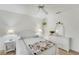 Bright bedroom featuring a white ceiling fan, an accent chair and neutral decor at 229 Sportsman Rd, Rotonda West, FL 33947