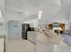 Bright kitchen with sleek cabinets, stainless appliances, tile flooring and an adjacent living area at 229 Sportsman Rd, Rotonda West, FL 33947
