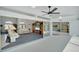 Open-concept living room with access to a screened-in patio, a ceiling fan and neutral paint at 229 Sportsman Rd, Rotonda West, FL 33947