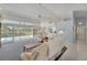 Open-concept living room with tile flooring, comfortable seating, and seamless access to the screened in pool area at 229 Sportsman Rd, Rotonda West, FL 33947