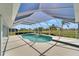 Screened-in pool area with tropical landscaping views and access to a covered patio at 229 Sportsman Rd, Rotonda West, FL 33947
