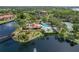 A scenic aerial image showcases the community's pristine lake, lush landscaping, and abundant trees at 23465 Harborview Rd # 842, Port Charlotte, FL 33980