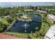 Beautiful aerial view of the community with a scenic lake, fountains, pool and lush landscaping at 23465 Harborview Rd # 842, Port Charlotte, FL 33980