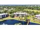 Beautiful aerial view of a condominium building overlooking a scenic pond with fountain at 23465 Harborview Rd # 842, Port Charlotte, FL 33980