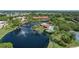 Beautiful aerial view of the community showcasing pond, pool, and tennis courts at 23465 Harborview Rd # 842, Port Charlotte, FL 33980